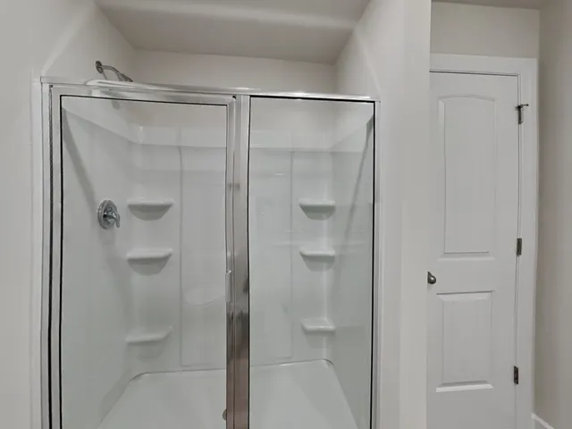 a bathroom with a glass shower door