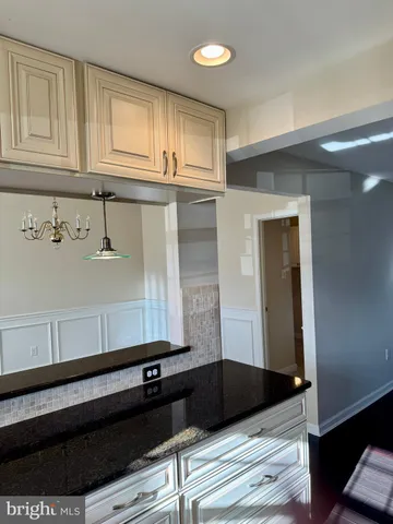 a bathroom with a sink a mirror and cabinets