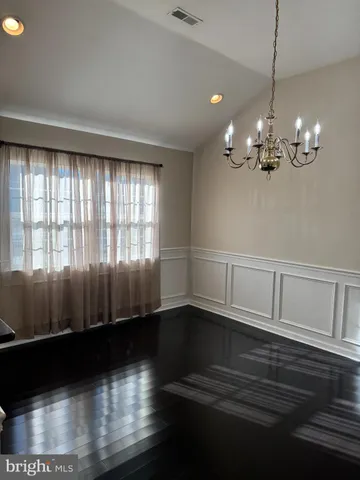 a view of a livingroom with wooden floor and a large window