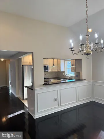 a kitchen with stainless steel appliances granite countertop a sink a stove and a wooden floors