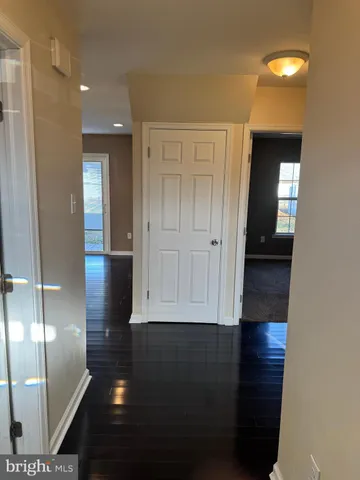 a view of hallway with wooden floor