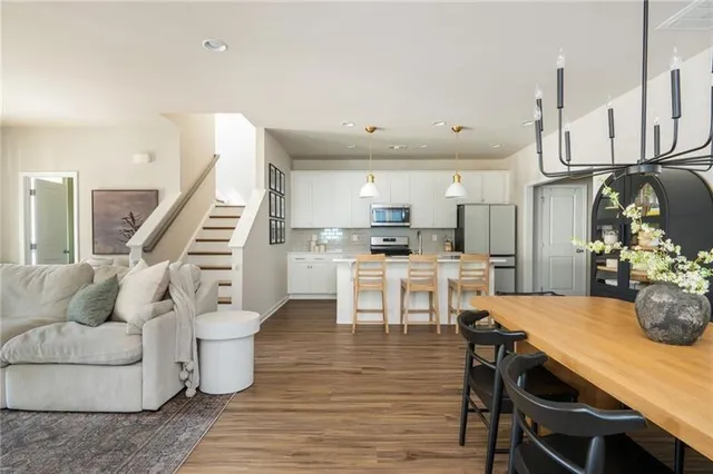a kitchen with granite countertop a sink stainless steel appliances and cabinets