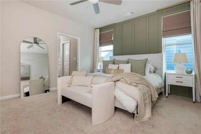 a bathroom with a granite countertop sink a mirror a bathtub and shower