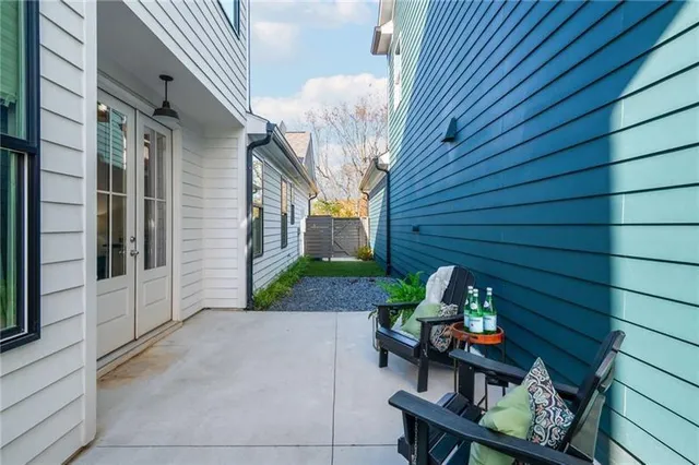 a view of a patio with table and chairs and potted plants