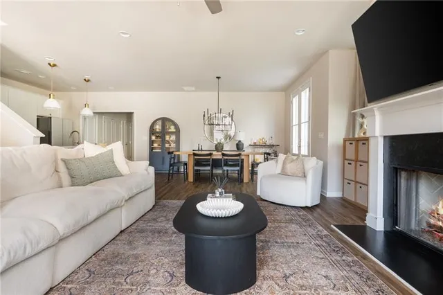 a living room with furniture a fireplace and a flat screen tv