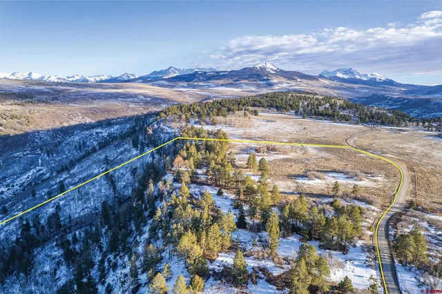 a view of a swimming pool and mountains in the background