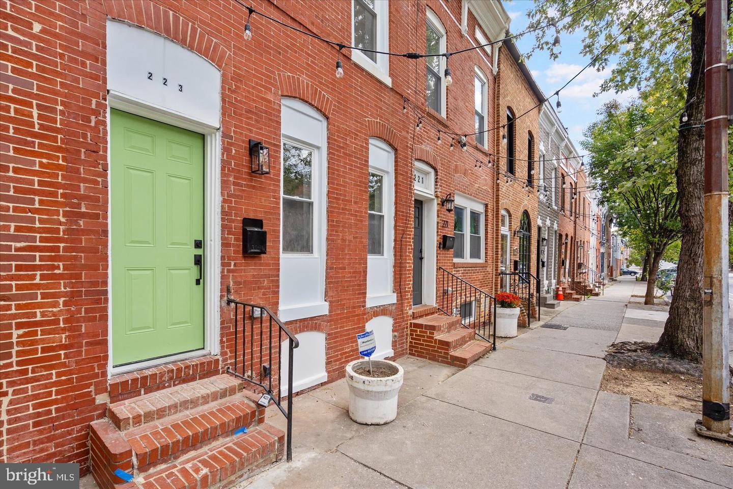 223 North Milton Avenue Baltimore, MD 21224 - Photo 13 of 14 a front view of a building with outdoor seating