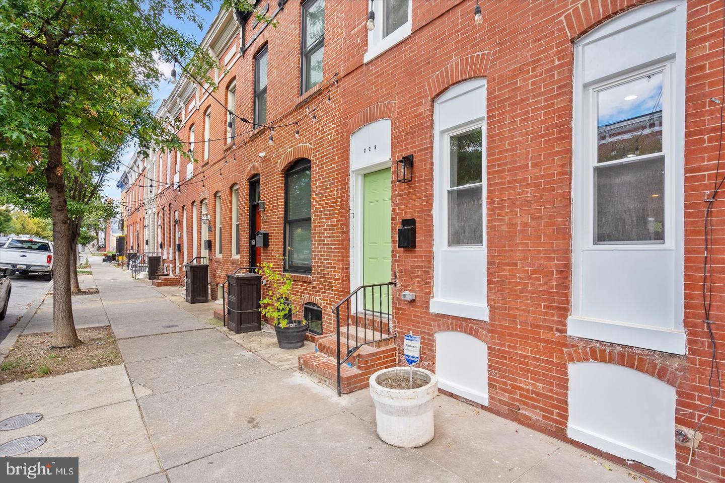 223 North Milton Avenue Baltimore, MD 21224 - Photo 14 of 14 a view of a building with bench potted plants