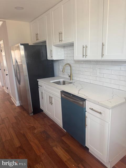 223 North Milton Avenue Baltimore, MD 21224 - Photo 4 of 14 a kitchen with a sink a refrigerator and cabinets
