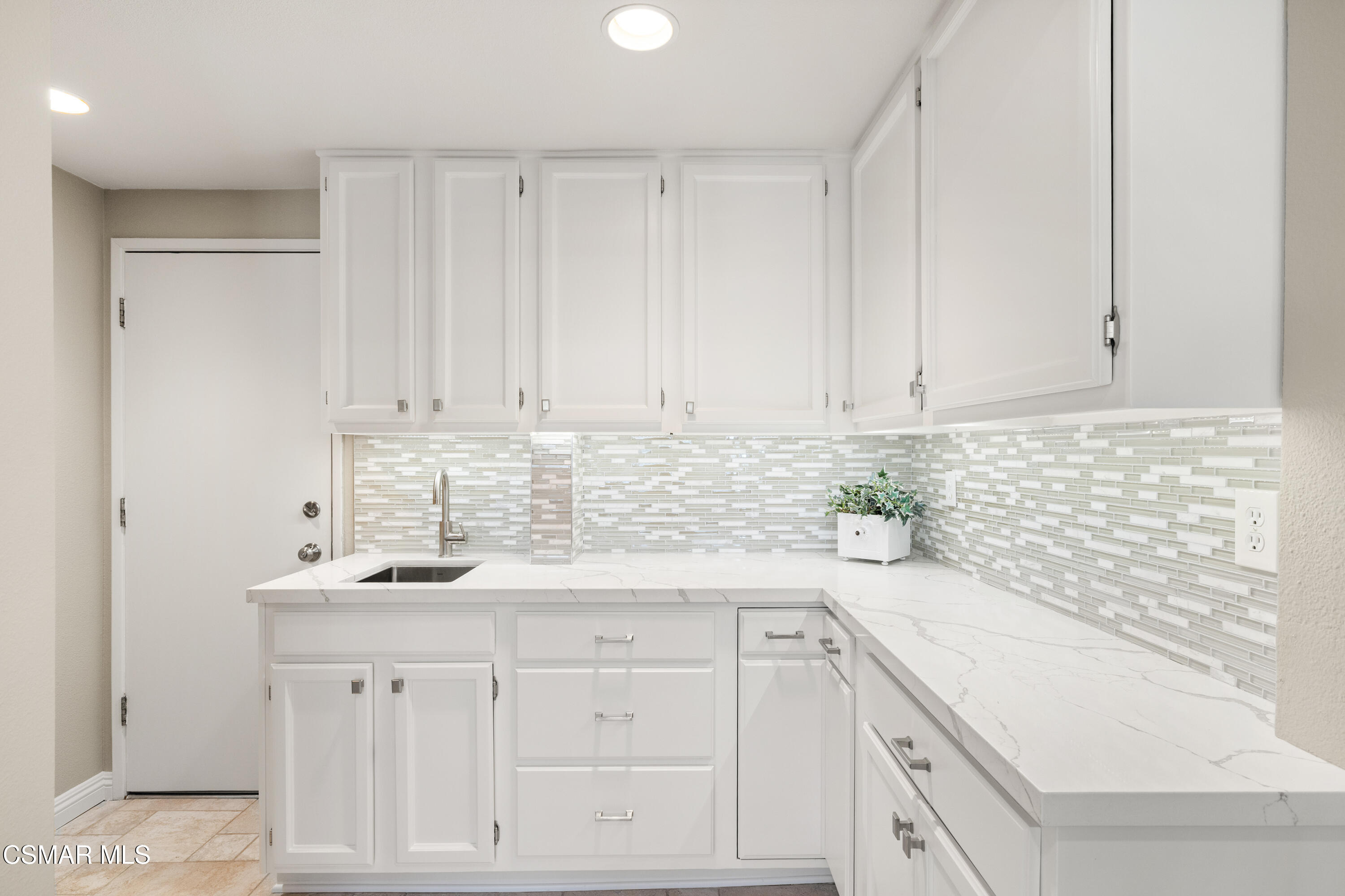 2489 North Greensward Street Simi Valley, CA 93065 - Photo 11 of 37 a kitchen with white cabinets