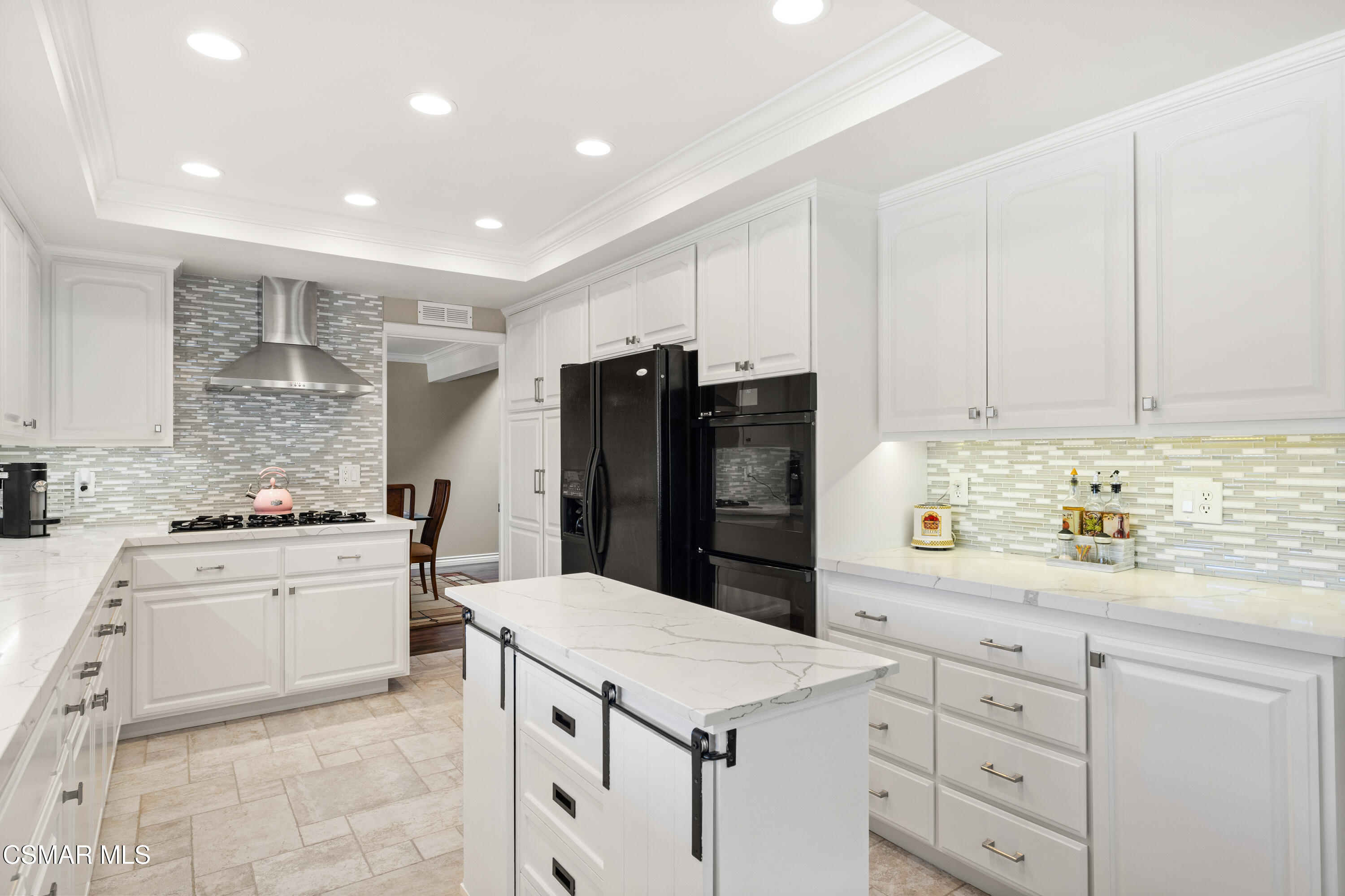 2489 North Greensward Street Simi Valley, CA 93065 - Photo 14 of 37 a kitchen with a sink a stove a refrigerator and white cabinets