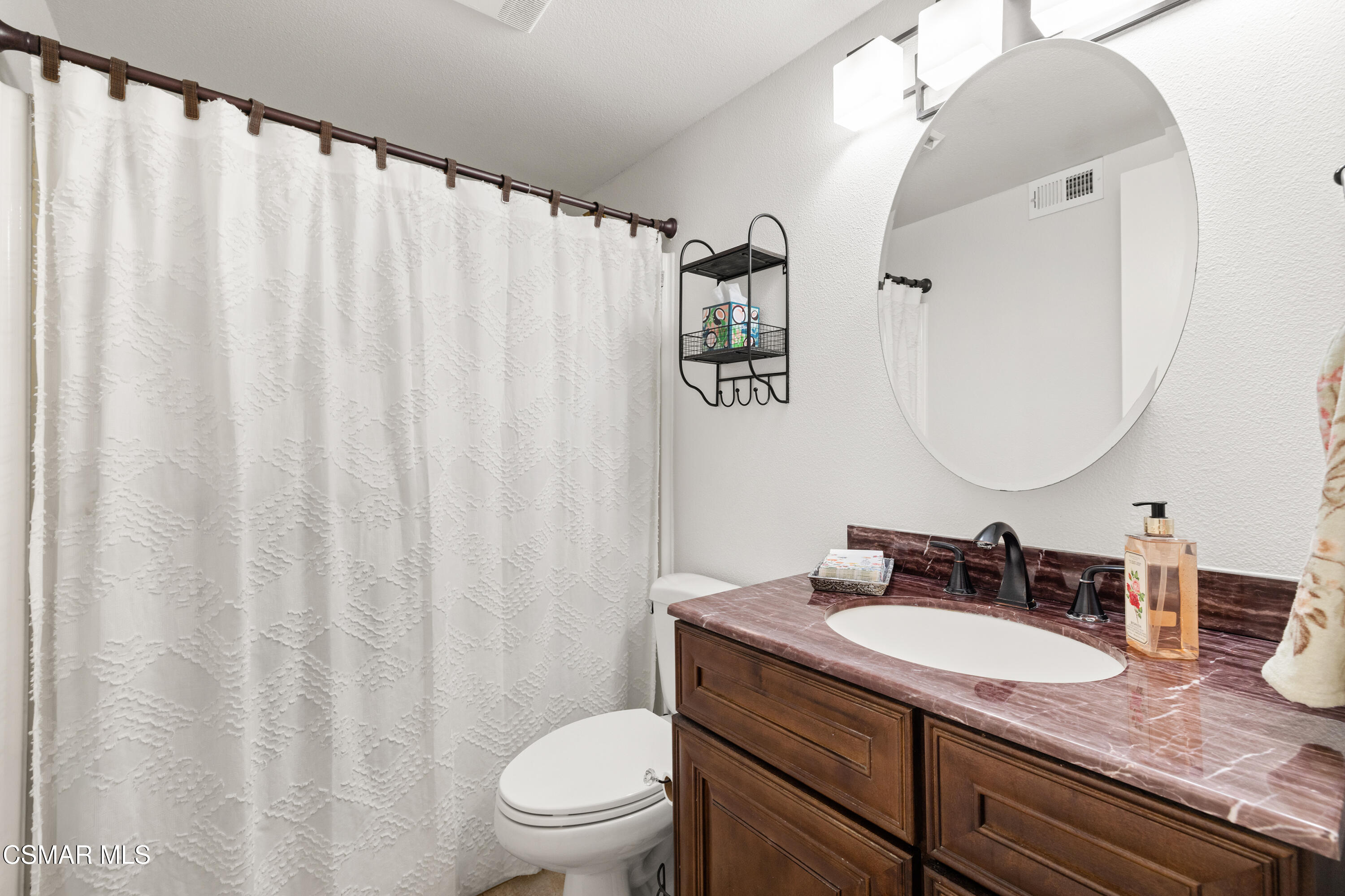 2489 North Greensward Street Simi Valley, CA 93065 - Photo 16 of 37 a bathroom with a granite countertop sink and a mirror with toilet