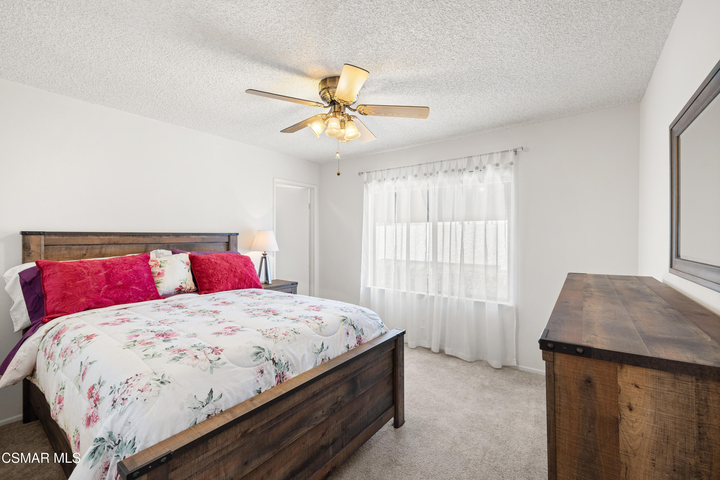 2489 North Greensward Street Simi Valley, CA 93065 - Photo 24 of 37 a bedroom with a bed and a chandelier