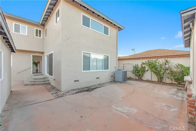 a view of a house with backyard and a porch