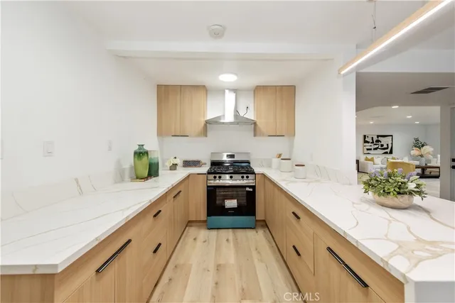 a large white kitchen with kitchen island white cabinets and stainless steel appliances