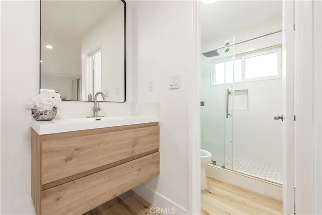 a bathroom with a shower sink and mirror
