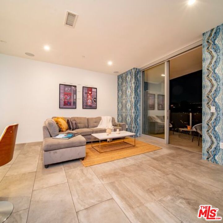2500 Vasanta Way Los Angeles, CA 90068 - Photo 15 of 22 a living room with furniture a flat screen tv and a large window