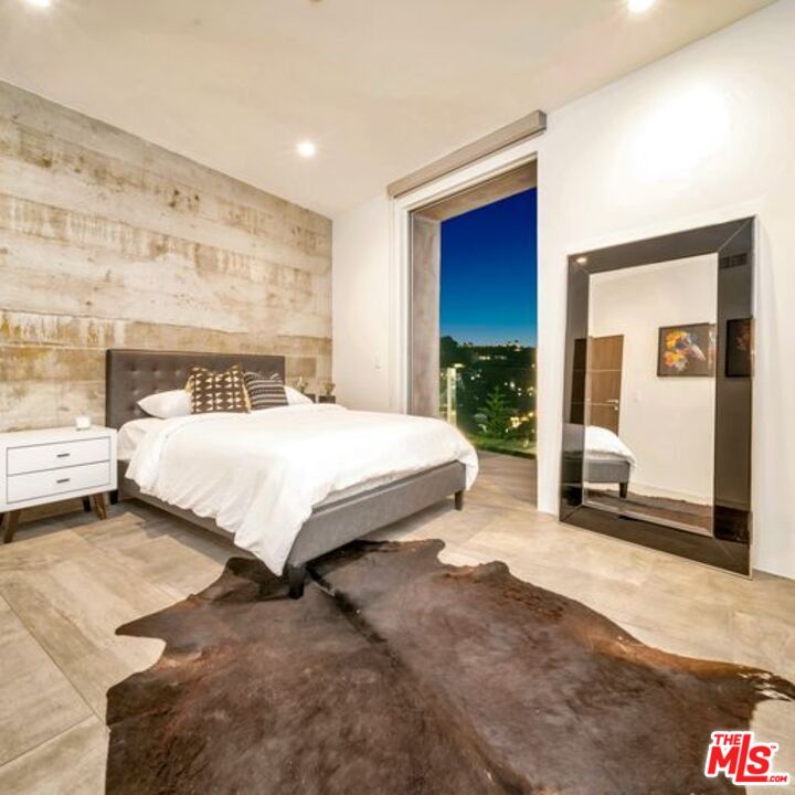 2500 Vasanta Way Los Angeles, CA 90068 - Photo 16 of 22 a bedroom with a bed and a large mirror