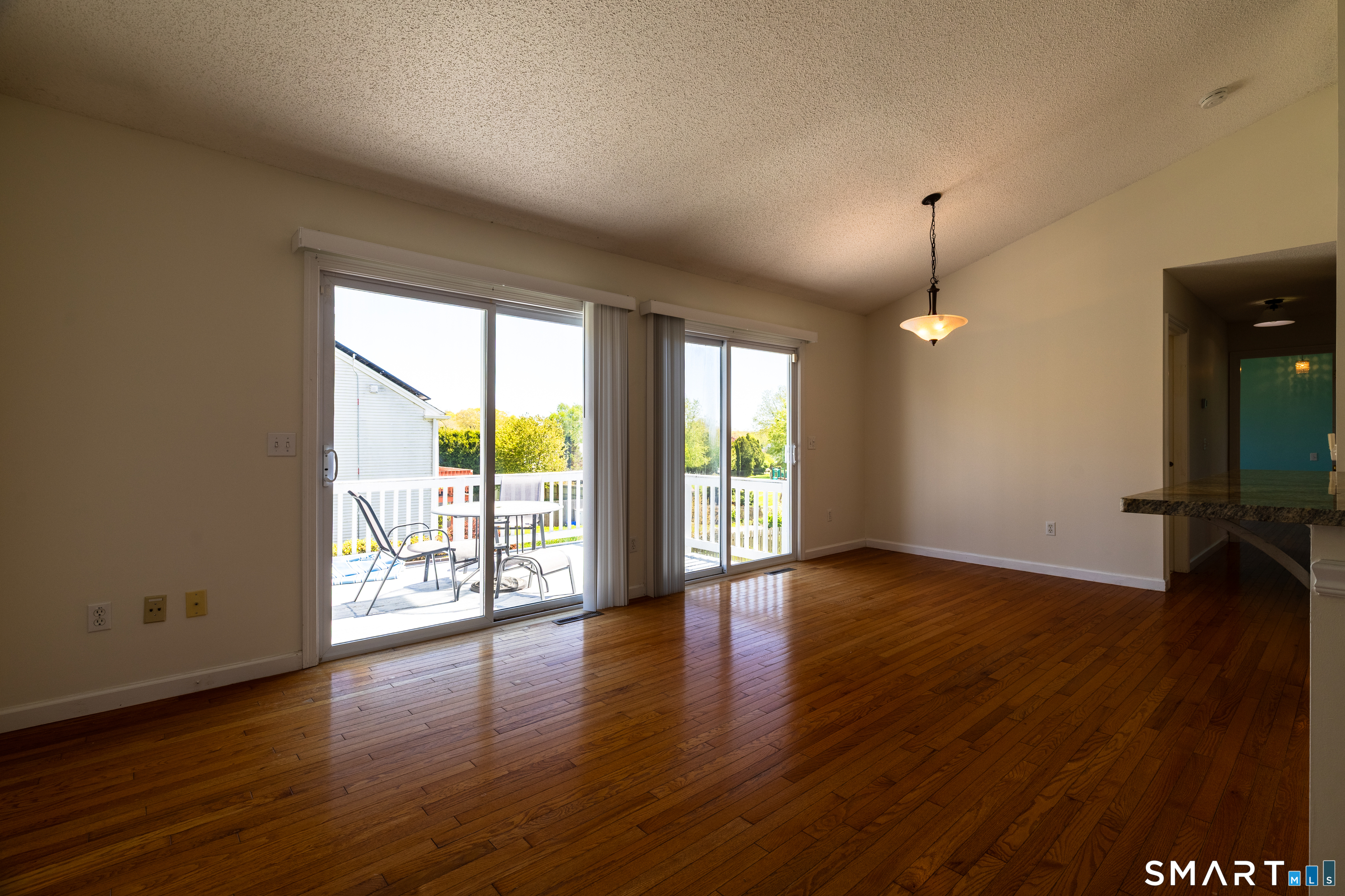 226 Noank Ledyard Road Groton, CT 06355 - Photo 3 of 26 an empty room with wooden floor and windows