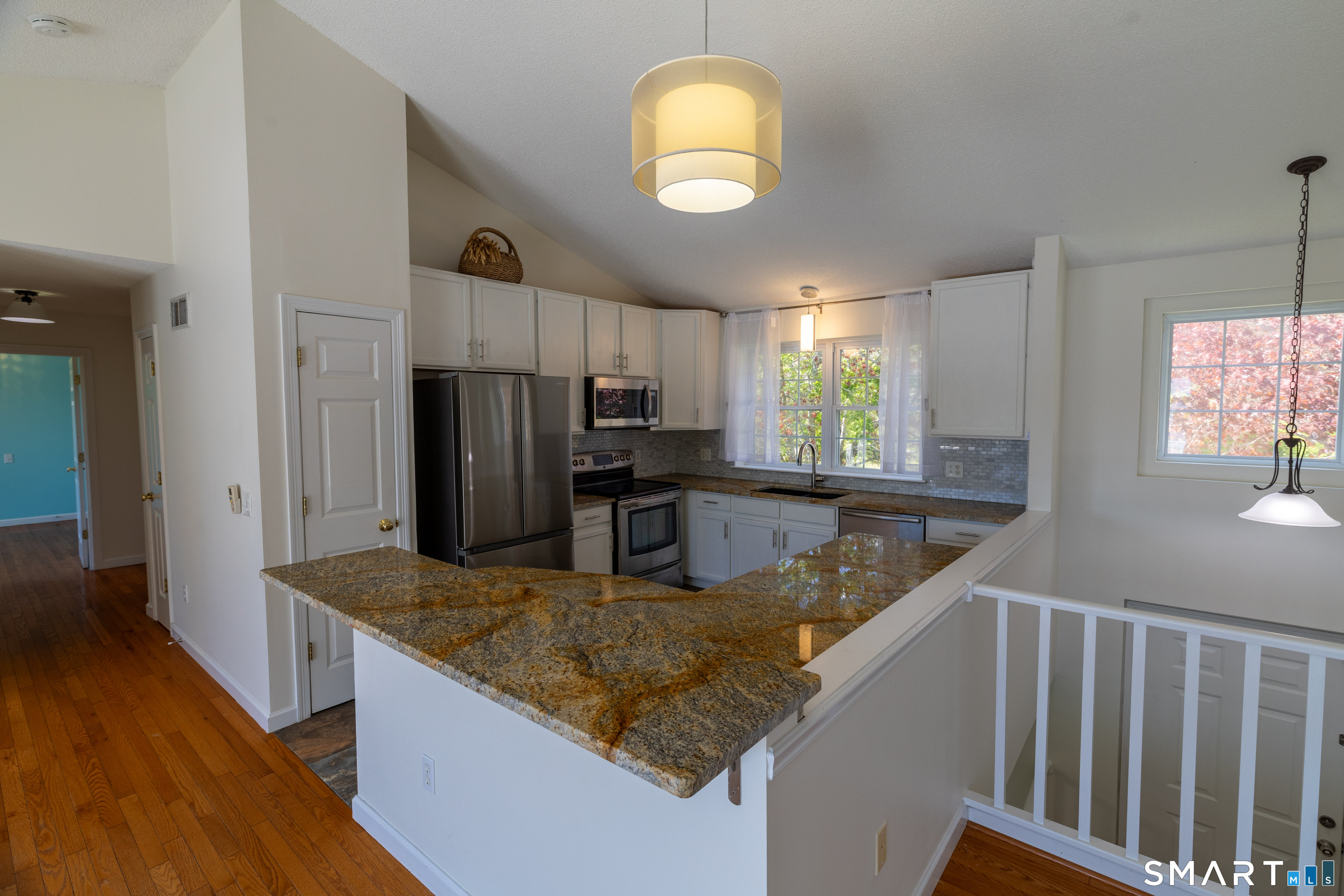 226 Noank Ledyard Road Groton, CT 06355 - Photo 7 of 26 a kitchen with stainless steel appliances granite countertop a sink a stove and a wooden floors