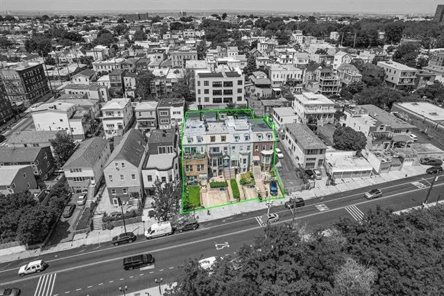 an aerial view of residential houses with outdoor space and street view