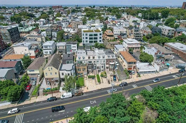 an aerial view of residential houses with green space