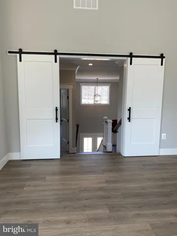 a view of a big room with wooden floor and stairs