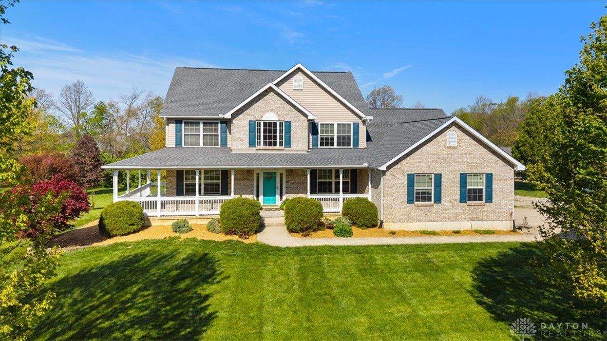 841 Willow Road Springfield, OH 45502 - Photo 58 of 64 This charming residence features an inviting front porch, a well-kept lawn, and lush landscaping.