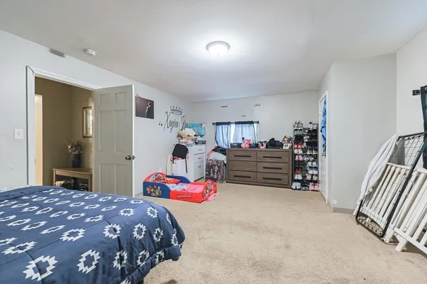 a bedroom with a bed and flat screen tv
