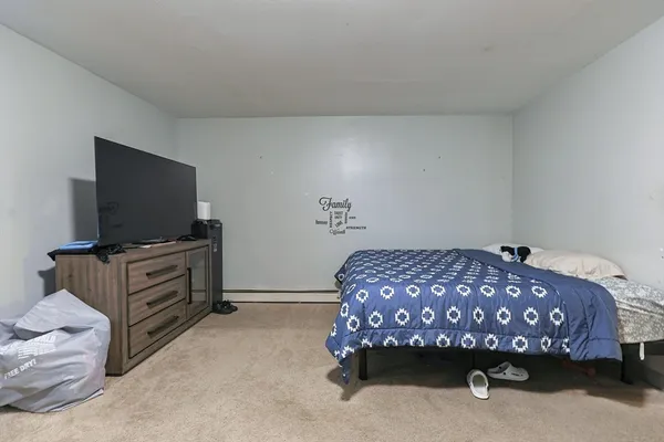 a bed room with a bed and a lamp