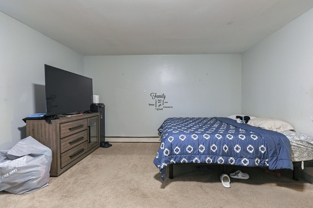 118 Maple Street Fall River, MA 02720 - Photo 12 of 36 a bedroom with a bed and flat screen tv