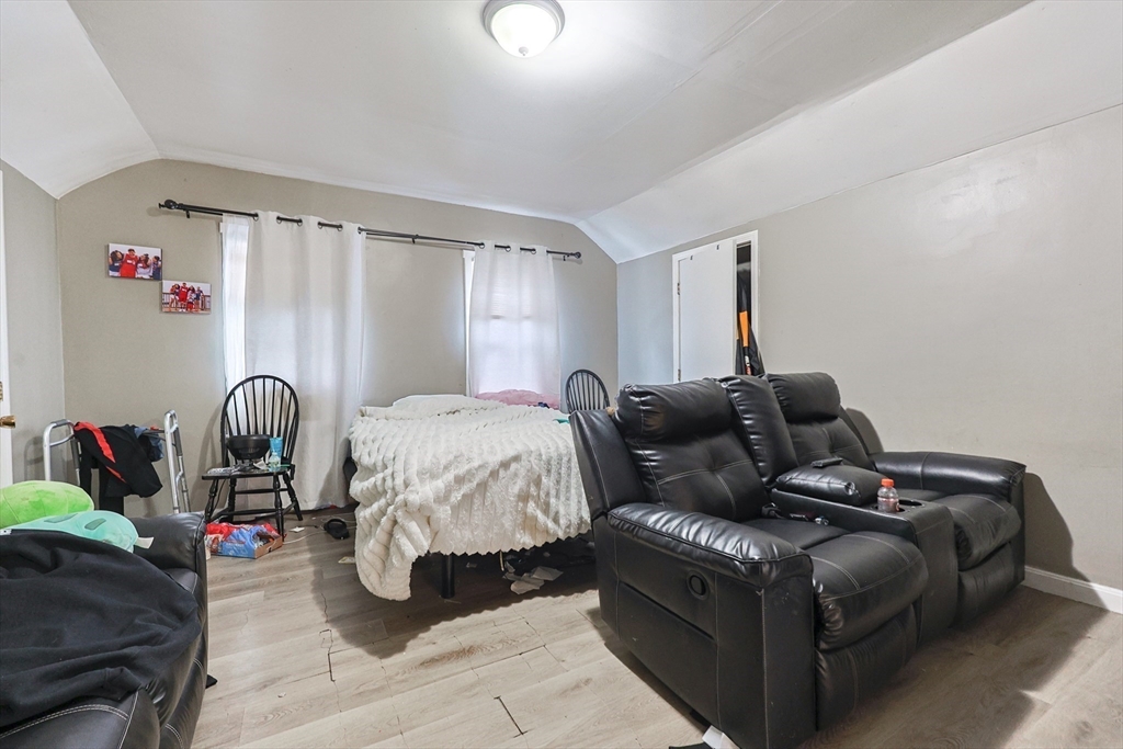 118 Maple Street Fall River, MA 02720 - Photo 13 of 36 a bed room with a bed and a lamp