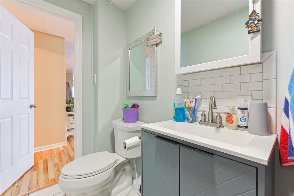 118 Maple Street Fall River, MA 02720 - Photo 18 of 36 a bathroom with a sink a toilet and a shower curtain