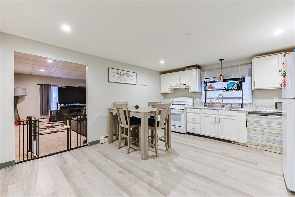 118 Maple Street Fall River, MA 02720 - Photo 6 of 36 a kitchen with white cabinets and stainless steel appliances