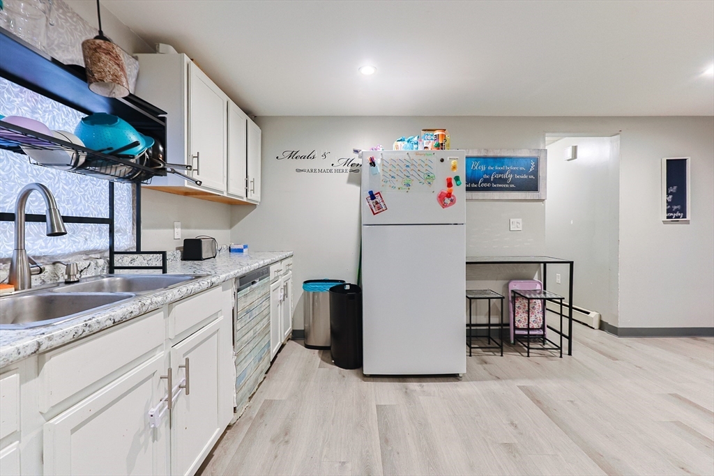 118 Maple Street Fall River, MA 02720 - Photo 7 of 36 a white kitchen with sink and wooden floor