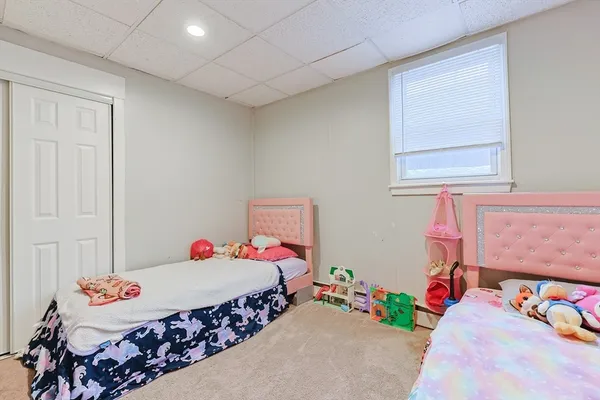 a bedroom with a bed and a couch