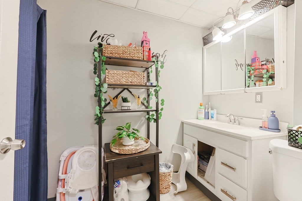118 Maple Street Fall River, MA 02720 - Photo 10 of 36 a bathroom with a sink mirror and vanity