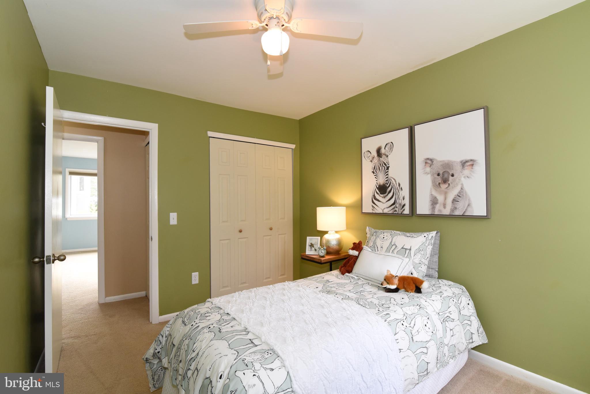 2334 Generation Drive Reston, VA 20191 - Photo 37 of 55 a bedroom with a bed and a chandelier