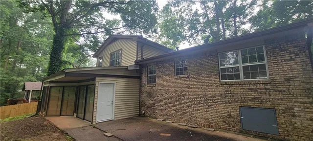 a front view of a house with a garden