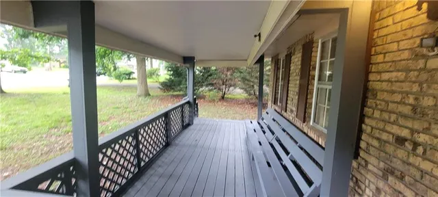 a view of balcony with wooden floor