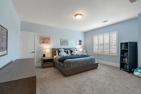 a spacious bedroom with a bed and a window