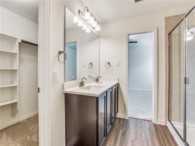 504 Brook View Court Anna, TX 75409 - Photo 9 of 10 a bathroom with a sink a mirror and a shower