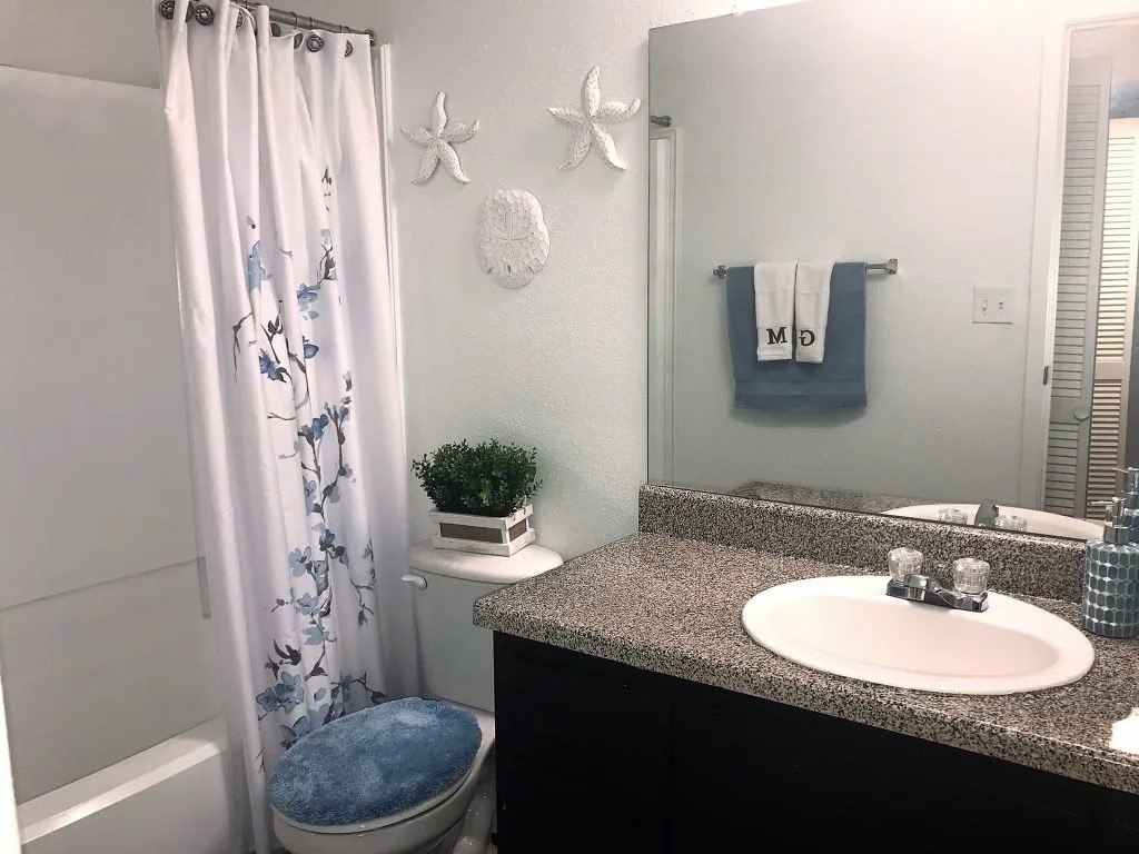 17310 Kieth Harrow Boulevard, Unit 213 Houston, TX 77084 - Photo 13 of 20 a bathroom with a granite countertop sink a toilet and a mirror