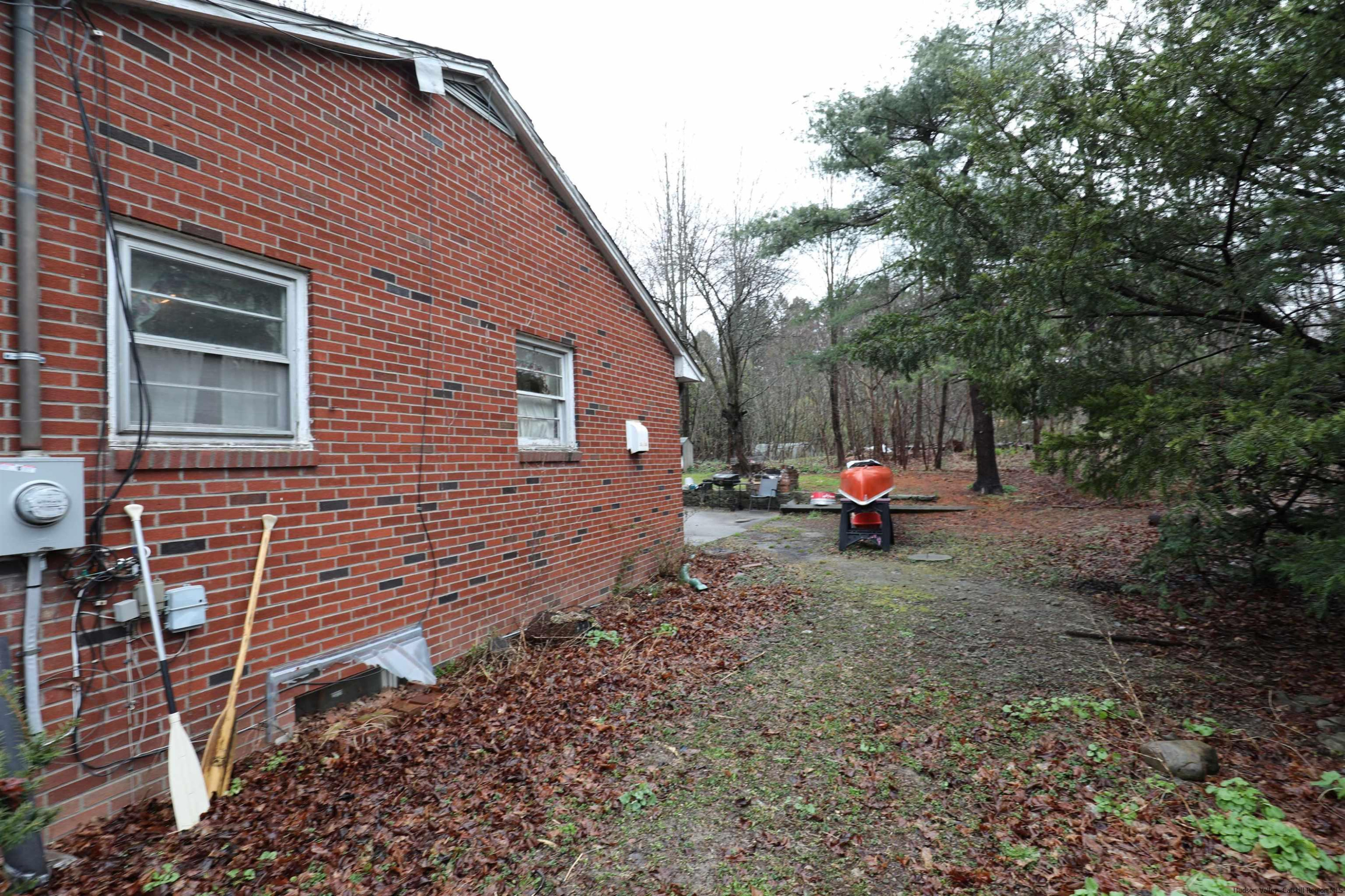 506 Plains Road Wallkill, NY 12589 - Photo 12 of 15 a view of a house with a backyard and a tree