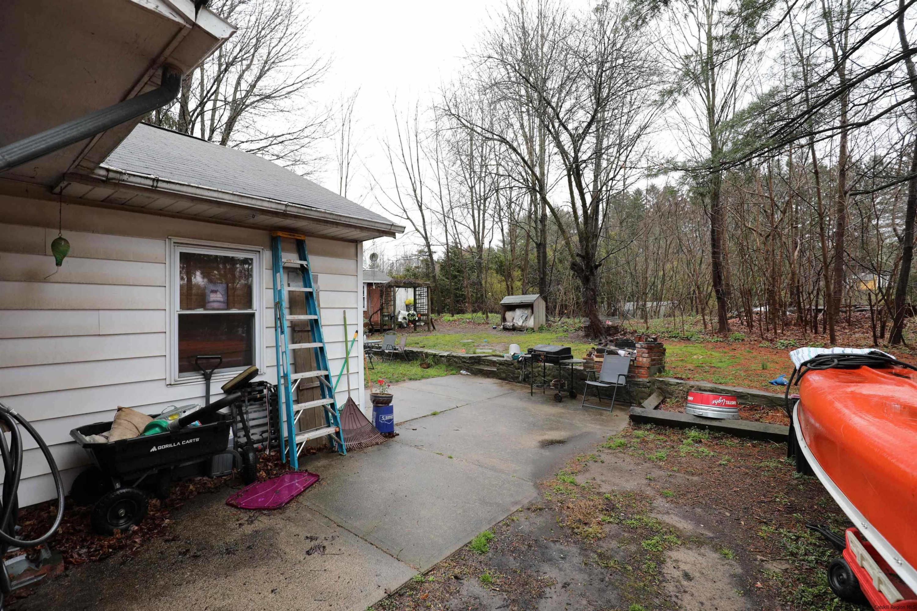 506 Plains Road Wallkill, NY 12589 - Photo 13 of 15 a view of a backyard with a large tree and a couch