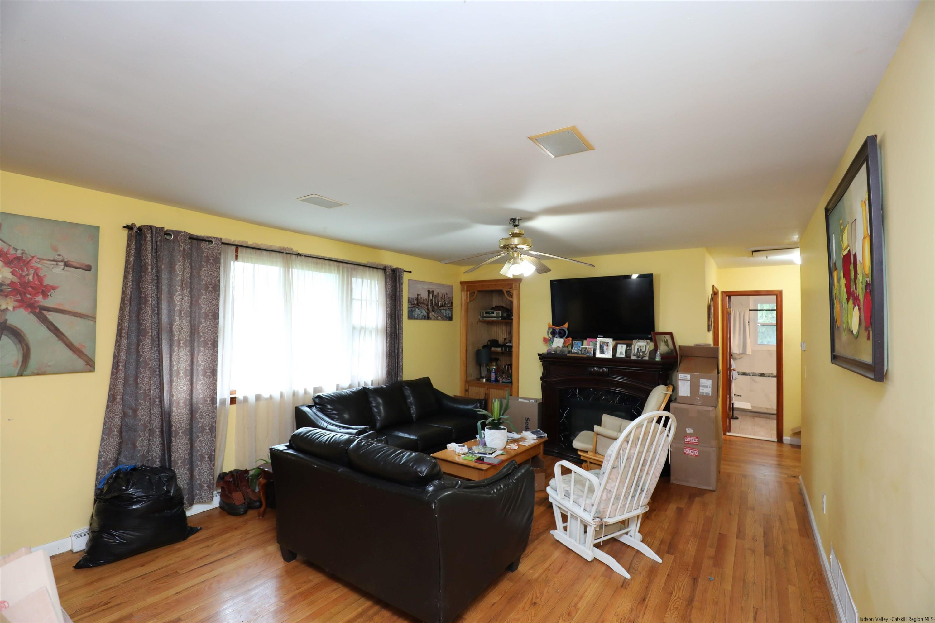 506 Plains Road Wallkill, NY 12589 - Photo 3 of 15 a living room with furniture and a flat screen tv