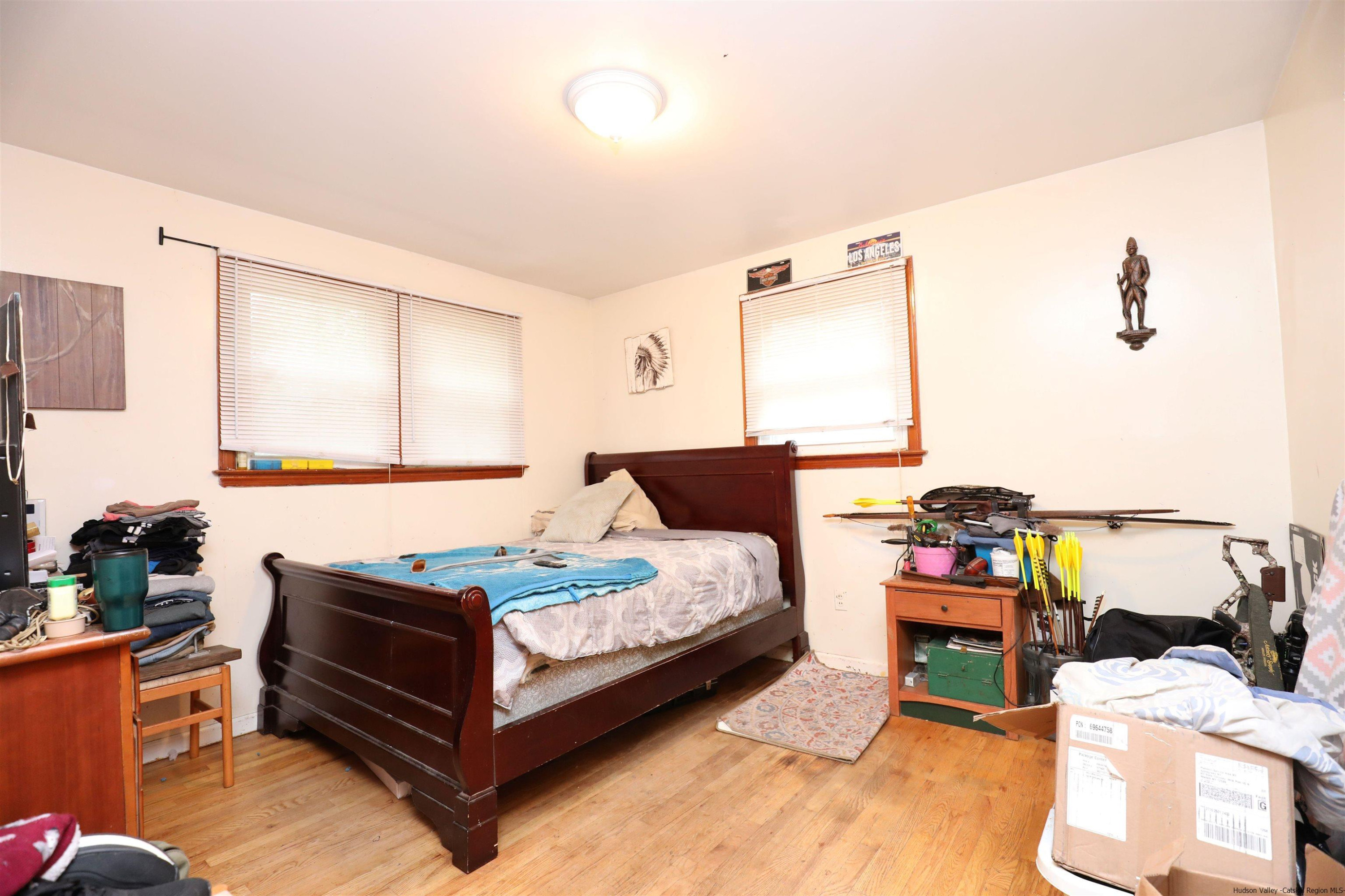 506 Plains Road Wallkill, NY 12589 - Photo 6 of 15 a bedroom with furniture and a wooden floor