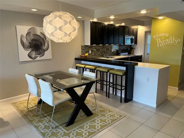 a bedroom with a bed and a lamp with the dresser