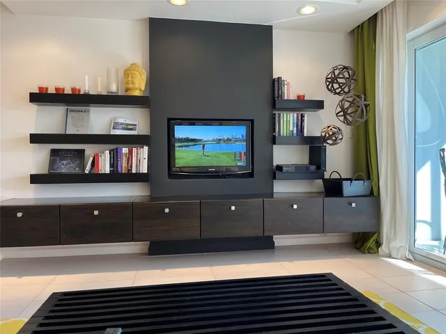a view of a balcony with wooden floor & fence