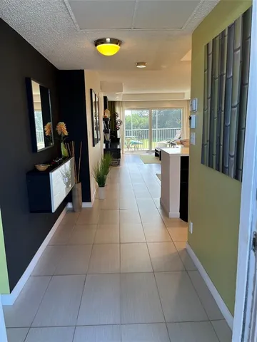 a living room with a couch and a bookshelf with wooden floor